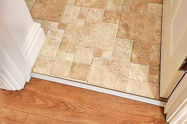 Replacement of kitchen vinyl flooring and hallway wood laminate with finishing trim